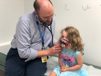 Cardiologist examines young child